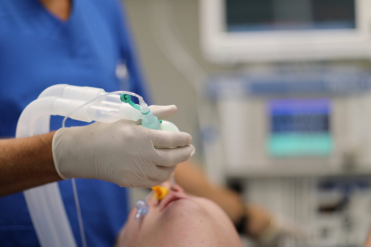 Anesthesia provider preparing airway equipment for general anesthesia