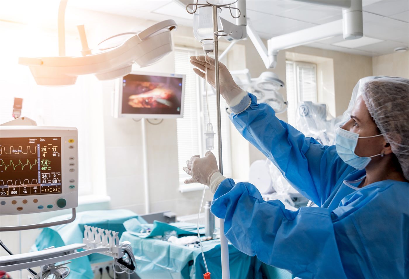 Anesthesia provider preparing an IV drip in a clinical setting